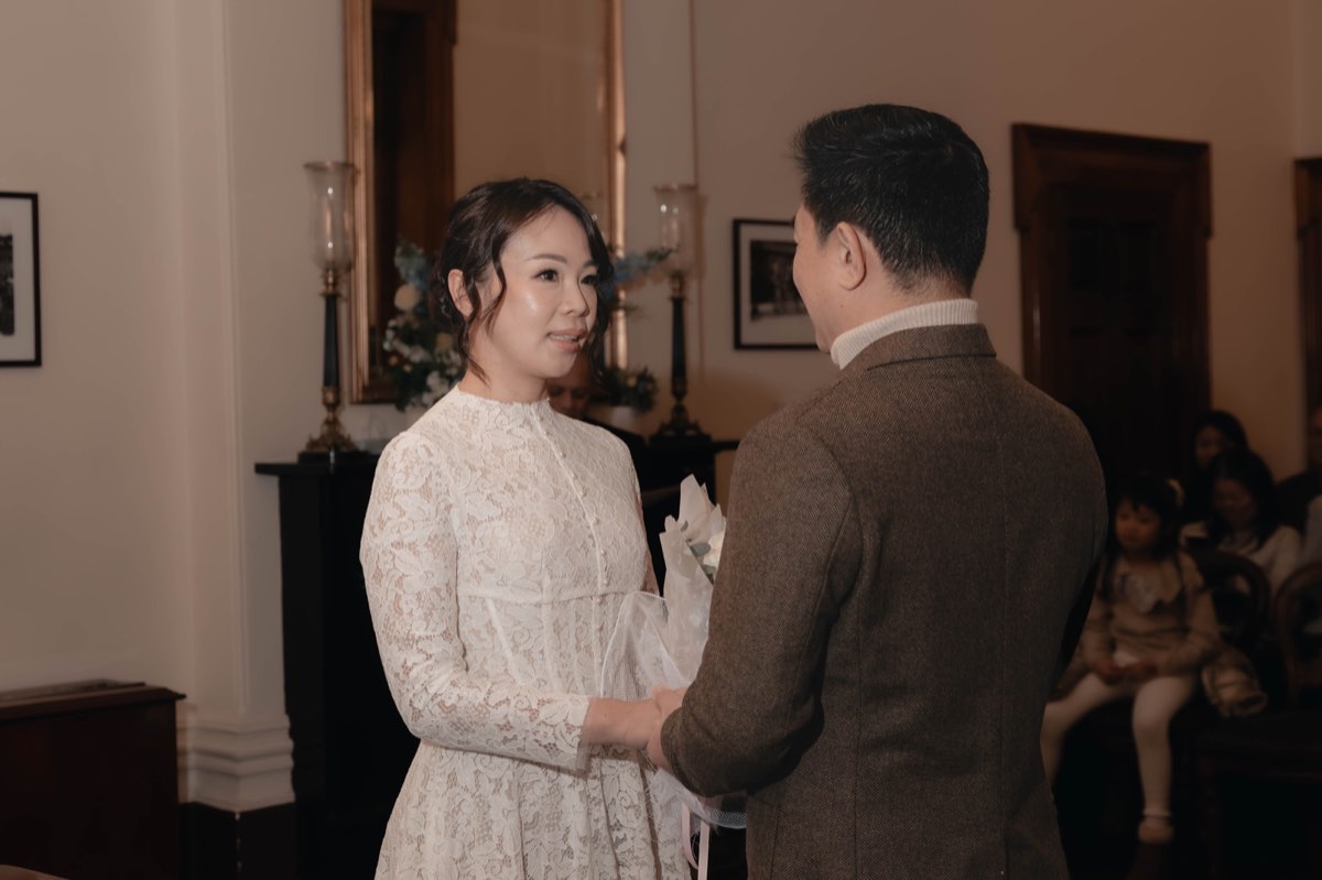 Bride and groom face each other during their vows in the registry room